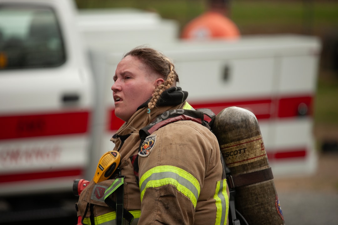 a-firefighter-wearing-protective-gear-and-oxygen-tank-ffv7-hw8u70