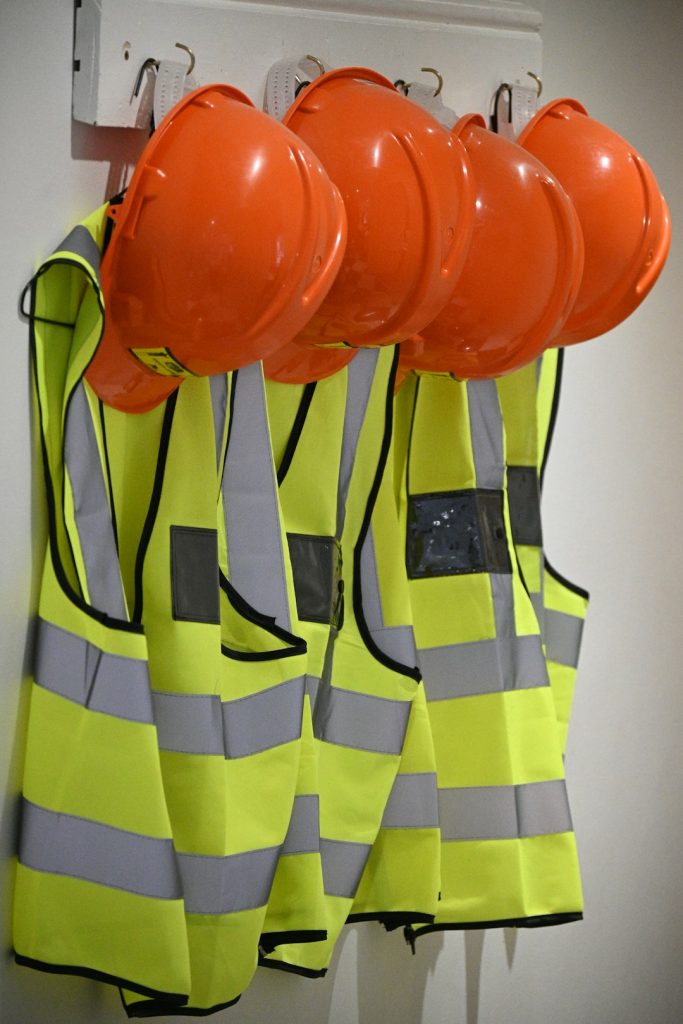 Yellow vest and orange hard hat safety equipment.