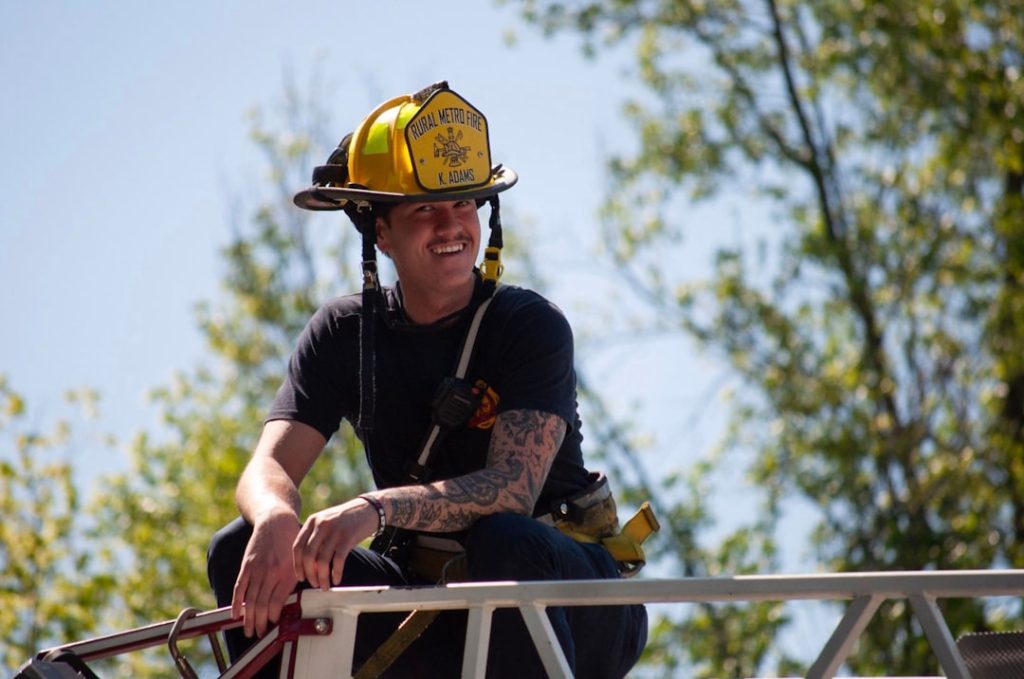 firefighter-wearing-helmet-and-gear-looking-away-c3o3wz2ymue